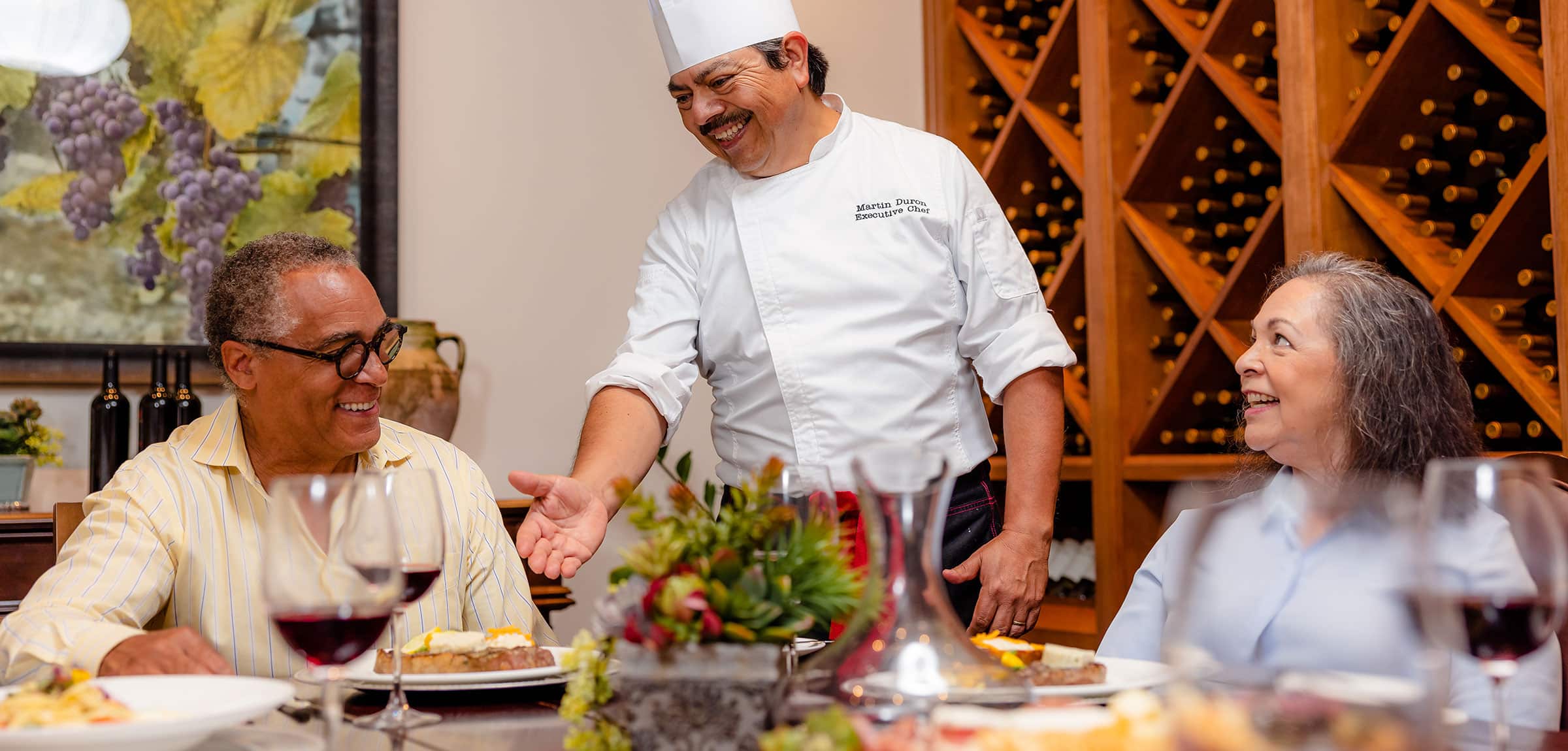 Chef talking to residents in wine room